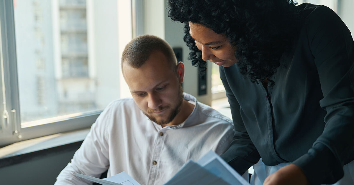 man and woman looking at paperwork together